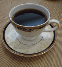 black coffee in ornate porcelain coffee cup