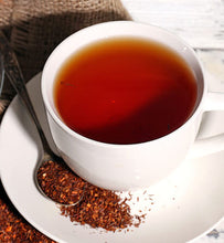 red rooibos in white cup with spoon