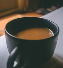 coffee with cream in a black coffee mug
