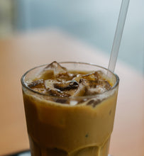 iced coffee in a clear glass with straw