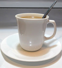 coffee in white ceramic coffee cup with spoon