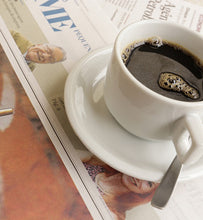 black coffee with spoon on Sunday newspaper