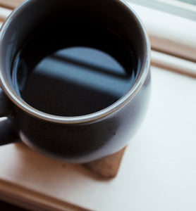 Township Park Blend in black coffee cup on window sill