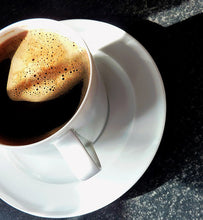 black coffee in white cup on dark granite table