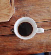 black coffee in white cup on a wooden table