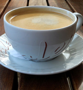 coffee in white porcelain cup with saucer