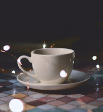 coffee in white coffee cup on colored tile surface