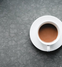 coffee in white cup on grey slate surface