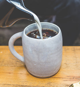 coffee in grey coffee mug with cream