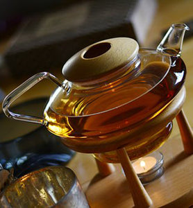 tea infusing in glass tea pot on wooden table
