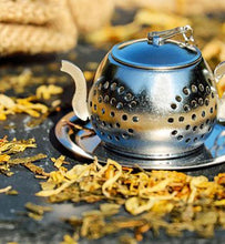 white tea brewing in stainless steel infuser