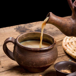 masa chai poured into brown ceramic cup